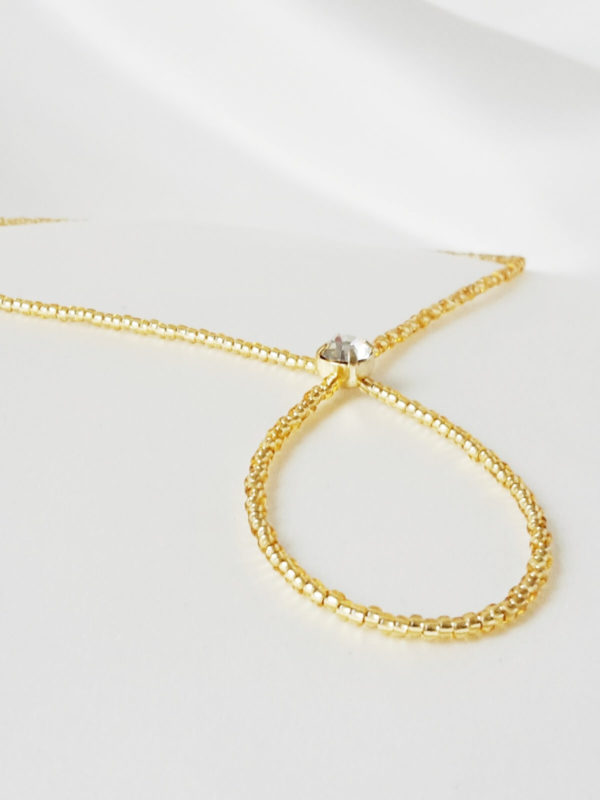 colllier-dos-perles-strass sautoir de dos pour la mariée en perles de rocailles dorées transparentes et cristaux de swarovski